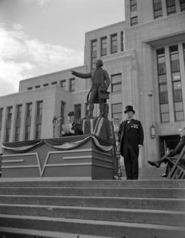 [The mayor possibly Gerry McGeer, and macebearer at the statue of George Vancouver for a ceremony]