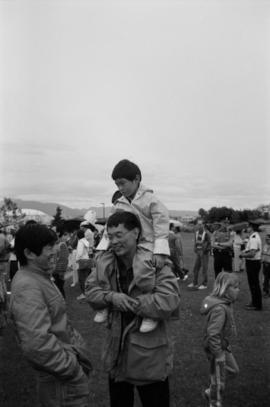 Paul Yee carrying Michael Yee on his shoulders at Charleson Park