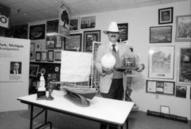 Mike Harcourt posing in a cowboy hat in front of gift display