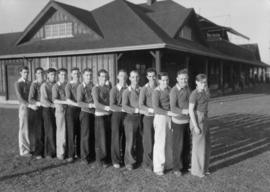 Softball teams and umpires [Softball team photo at the park]