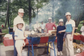 People assembled around barbecue