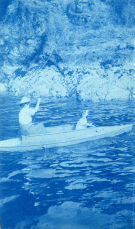 [Unidentified woman and girl in canoe near shore]