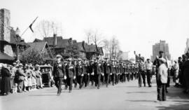 [A parade on Georgia Street travelling west towards Thurlow Street]