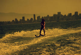 [Person water skiing with Downtown Vancouver in the background]