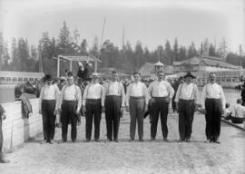Men standing on a racetrack at Hastings Park