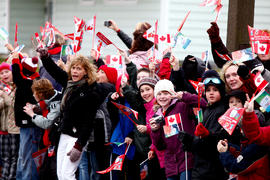 Day 27 Crowd cheers on the flame as it passes in New Brunswick.