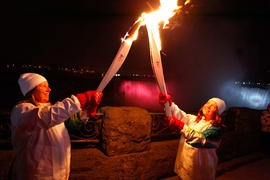 Day 52 Torchbearer 200 Susan Phillips passes the flame to Torchbearer 201 in front of Niagra Fall...