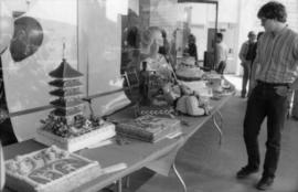 Man viewing birthday cakes on display