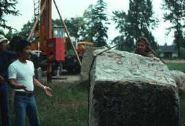 Stone being moved by crane; left to right: Jiro Sugawara and assistant carver