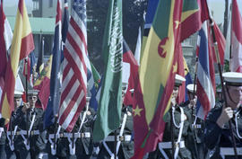 Men in uniform marching with flags