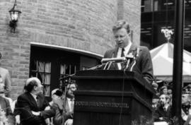 Unidentified man speaking from podium