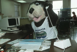 Tillicum on the telephone at an office desk in Vancouver City Hall