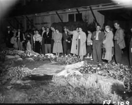 Crowd looking at exhibit in horticultural display in P.N.E. Forum