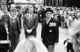Michael Francis, Mike Harcourt and two unidentified men in front of press