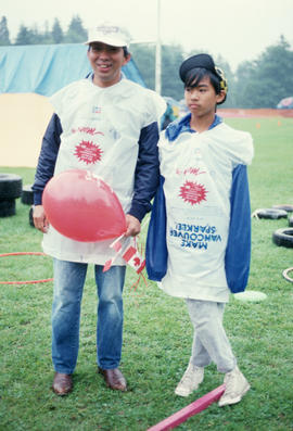 Two participants wearing Centennial rain covers during Canada Day celebrations