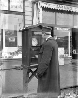 [Motorman using time clock to report to Control Office from the end of a remote streetcar line]