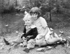 [A boy and girl feeding the birds at Charles E. Jones' Birds' Paradise]