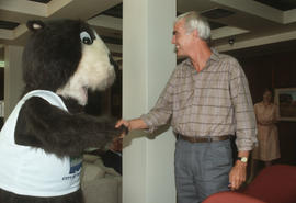 Tillicum shaking hands with a Centennial Committee member at Vancouver City Hall
