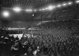 [Military ceremony inside arena]