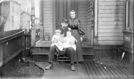 [Captain William Hugh McPhie and family in front of their house]