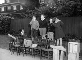 [Children selling seats along procession route during visit of King George VI and Queen Elizabeth]