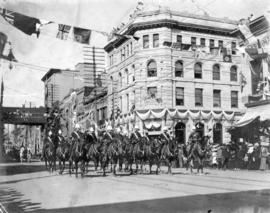 [Northwest Mounted Police escort the Duke and Duchess of Cornwall and York on Hastings Street]