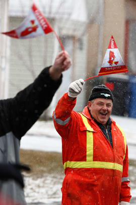 New Day 32 Man cheers on the flame as it passes in Quebec.