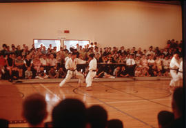 [Karate sparring in front of a crowd]