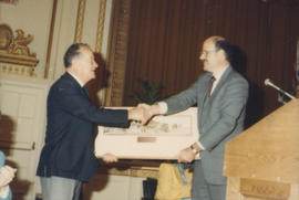 Mike Harcourt presents framed print to unidentified man