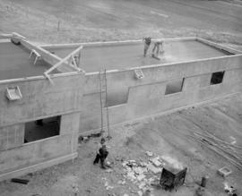 Applying the roofing to the factory garage