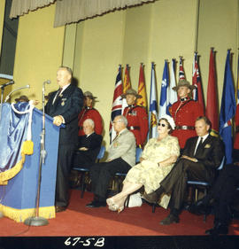 Lieutenant Governor G.R. Pearkes speaking at 1967 P.N.E. opening ceremonies on Outdoor Theatre stage