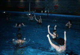 [Adults in water aerobics class]