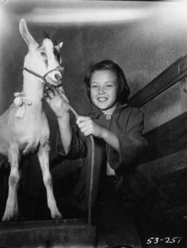 Young girl posing with small goat