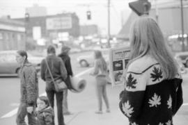 Girl sells magazines outside the Vancouver Public Library