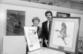 May Brown and unidentified man holding prints from the Centennial gift program