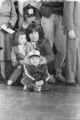 Mother and children seated on floor