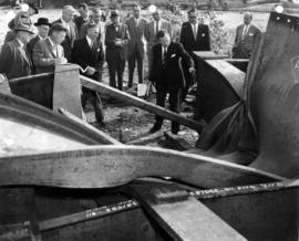 A group of men examine wreckage from the Second Narrows Bridge collapse