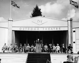 Prime Minister John Diefenbaker at podium with other officials on stage