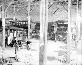 [Various electrically operated vehicles inside B.C. Electric Railway Company garage at Carrall St...