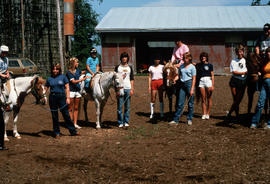 Children at stables riding horses