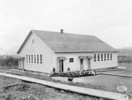 [A group of students outside Sir Matthew Begbie (Block Seventy) School at the corner of Kitchener...