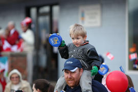 Day 100 Young boy cheers on the flame with his RBC tambourine in British Columbia.