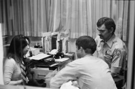 Pender Guy volunteers and a Vancouver Police officer at an on-air broadcast from Strathcona Commu...