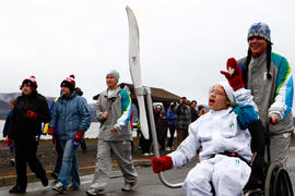 New Day 30 Torchbearer Katie Martin 30 carries the flame in Campbellton, New Brunswick.