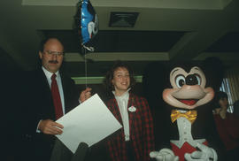 Mike Harcourt, unidentified woman and Mickey Mouse at City Hall