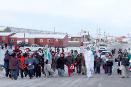 Day 7 Torchbearer 3 Gavin Ayalik runs the flame in Kugluktuk.