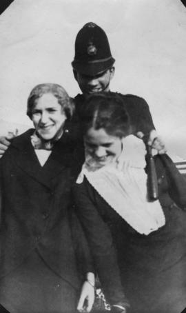 Unidentified police constable with two women in handcuffs