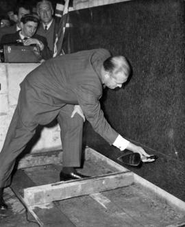 [Robert H. Winter tapping corner stone at the Post office]