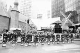 Group in kilt uniforms in front of Castle Vancouver