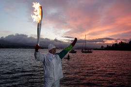 Day 105 Torchbearer 20 Bob Morrell carries the flame in Stanley Park, British Columbia.